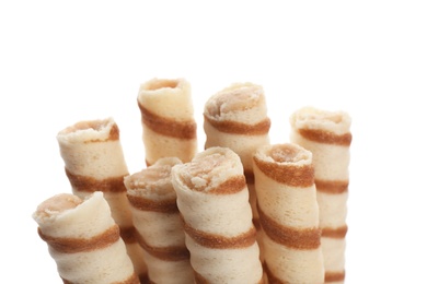 Photo of Tasty wafer roll sticks on white background, closeup. Crispy food