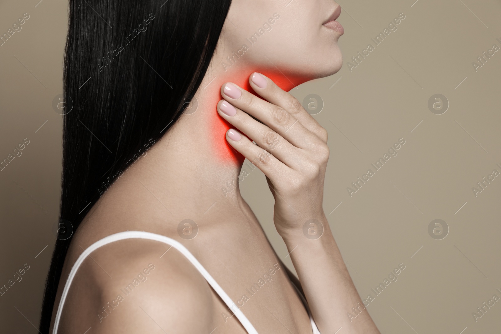 Image of Endocrine system. Woman doing thyroid self examination on beige background, closeup