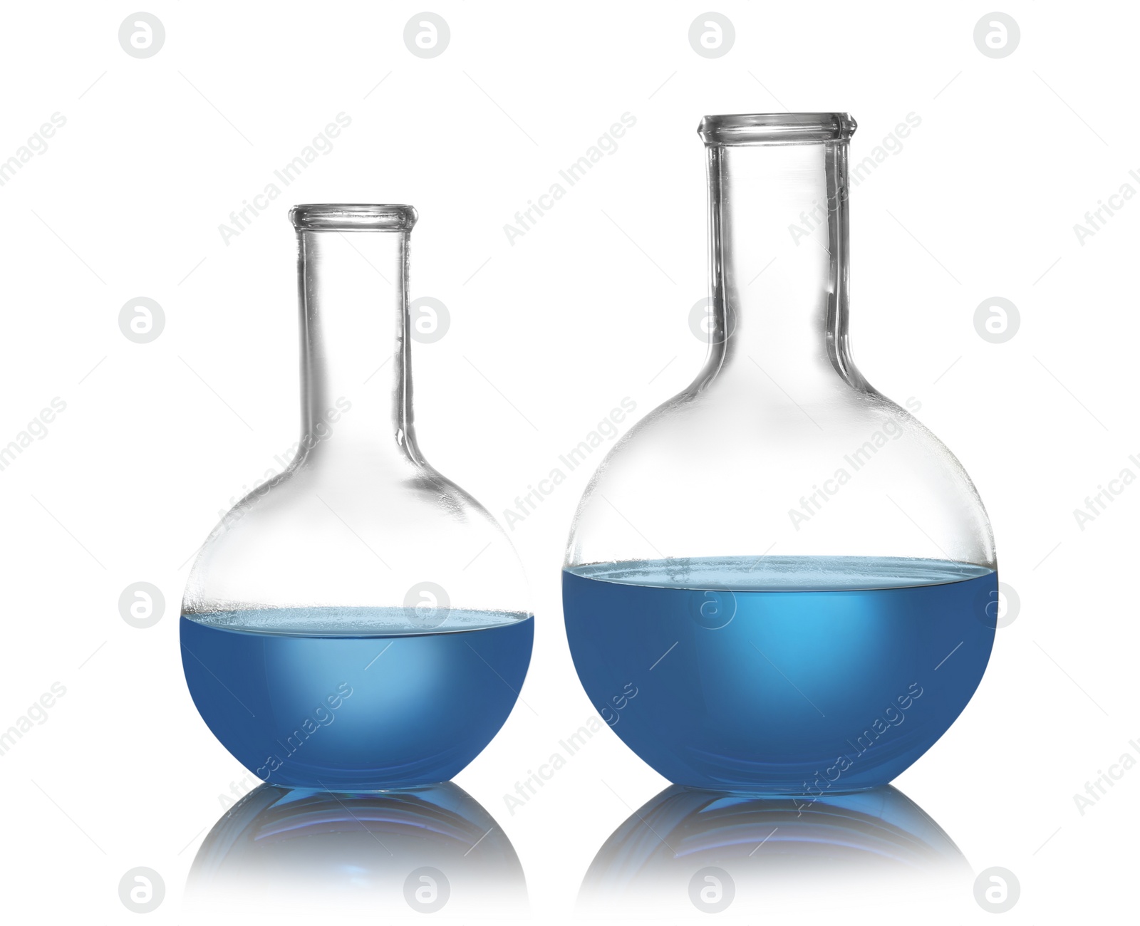 Photo of Florence flasks with liquid samples on white background. Chemistry glassware