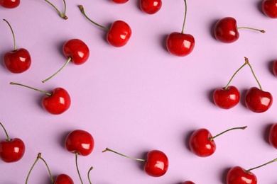 Photo of Flat lay composition with sweet cherries on lilac background. Space for text