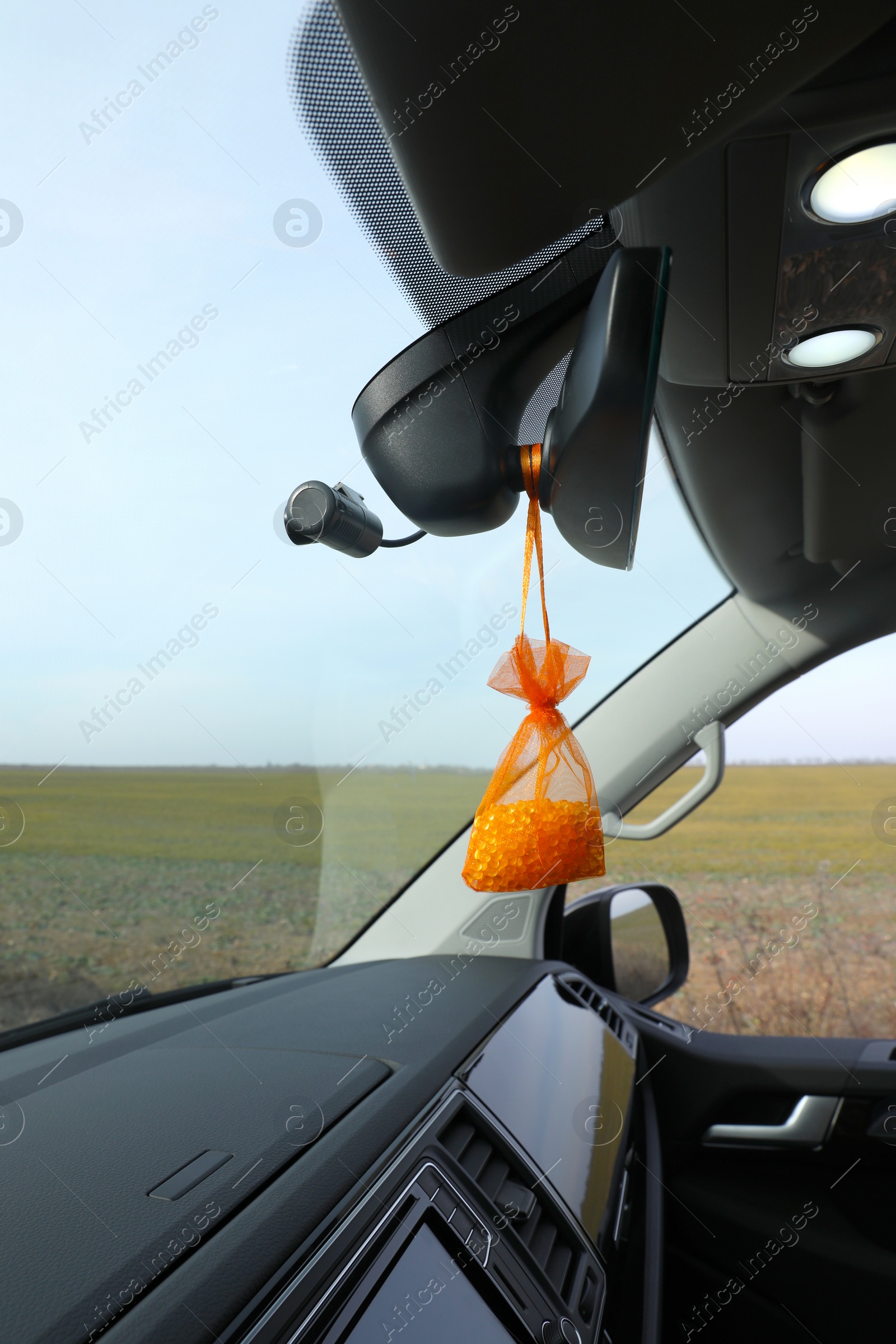 Photo of Air freshener hanging on rear view mirror in car