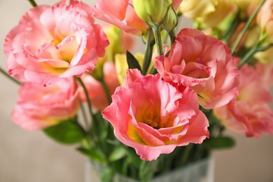 Photo of Beautiful Eustoma flowers against beige background, closeup