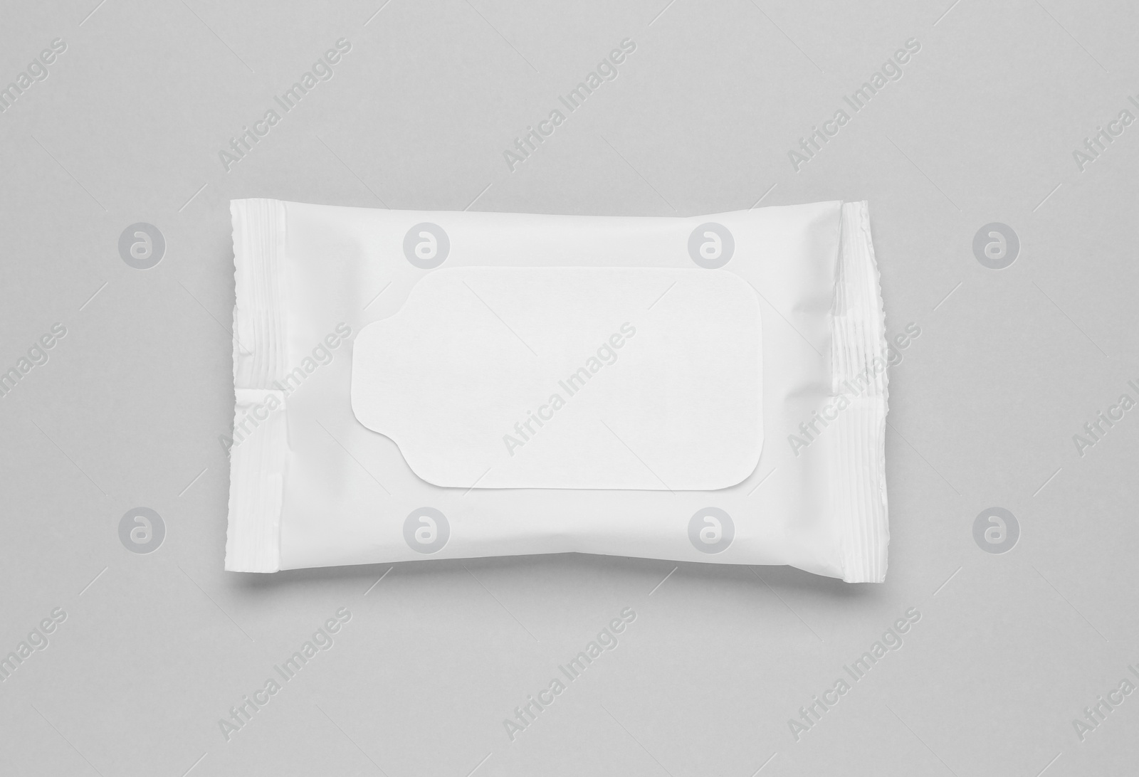 Photo of Wet wipes flow pack on light grey background, top view