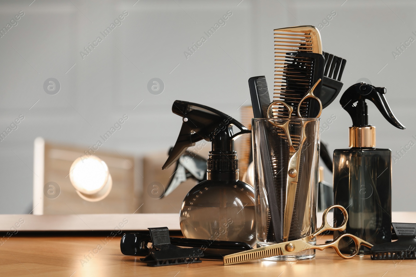 Photo of Set of hairdresser tools on table in salon, space for text