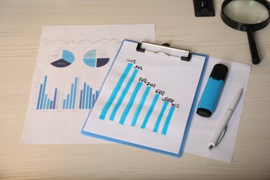 Photo of Business process planning and optimization. Workplace with different graphs and other stationery on wooden table