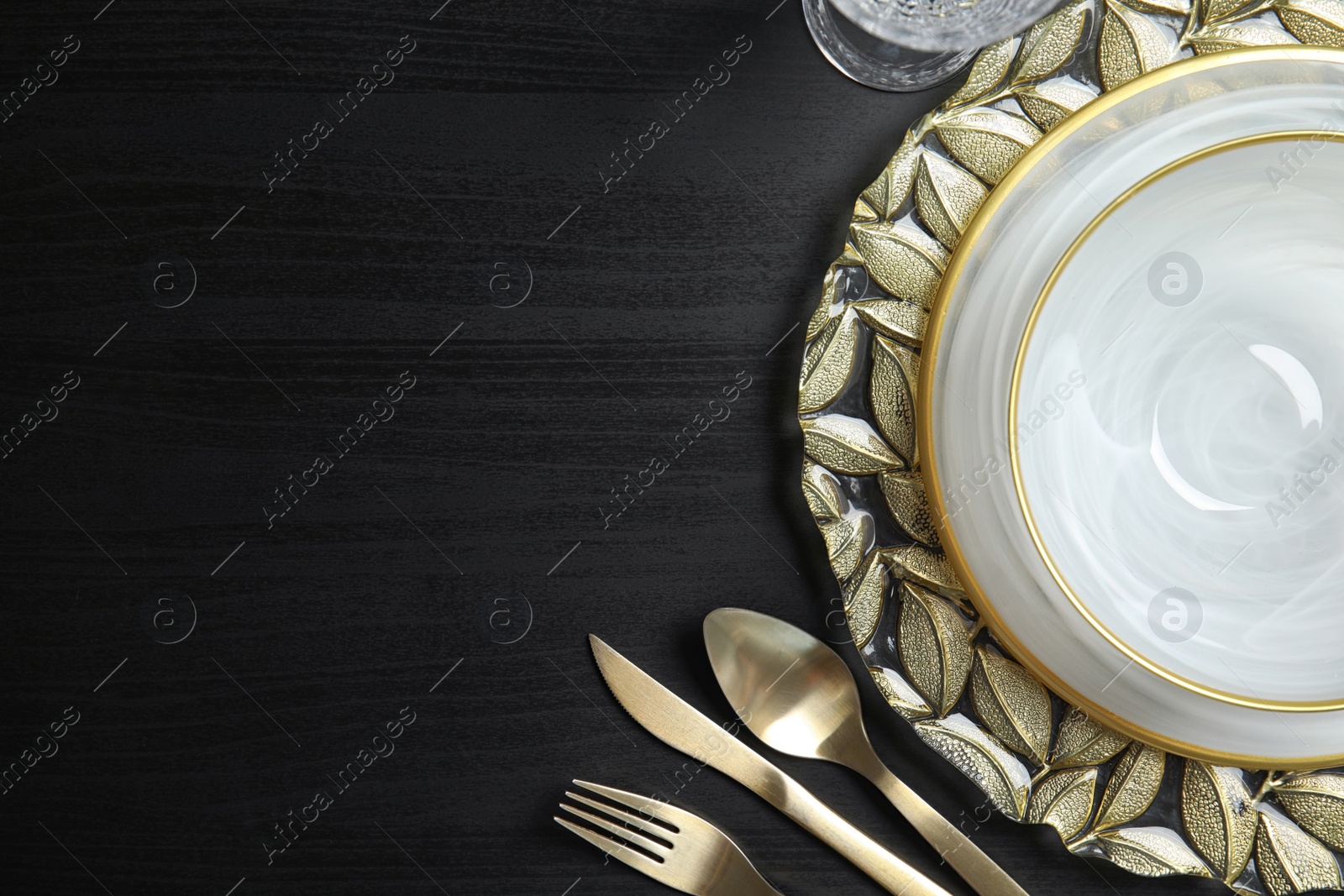 Photo of Elegant table setting and space for text on dark background, top view