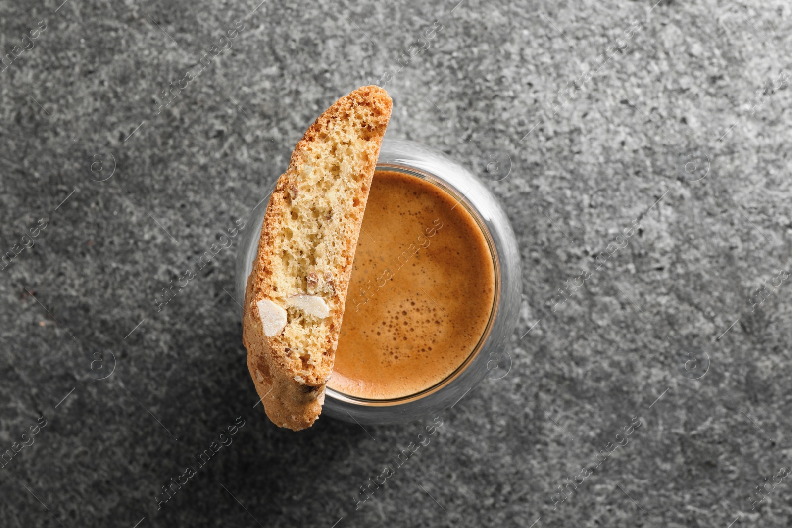 Photo of Tasty cantucci and cup of aromatic coffee on grey table, top view. Traditional Italian almond biscuits