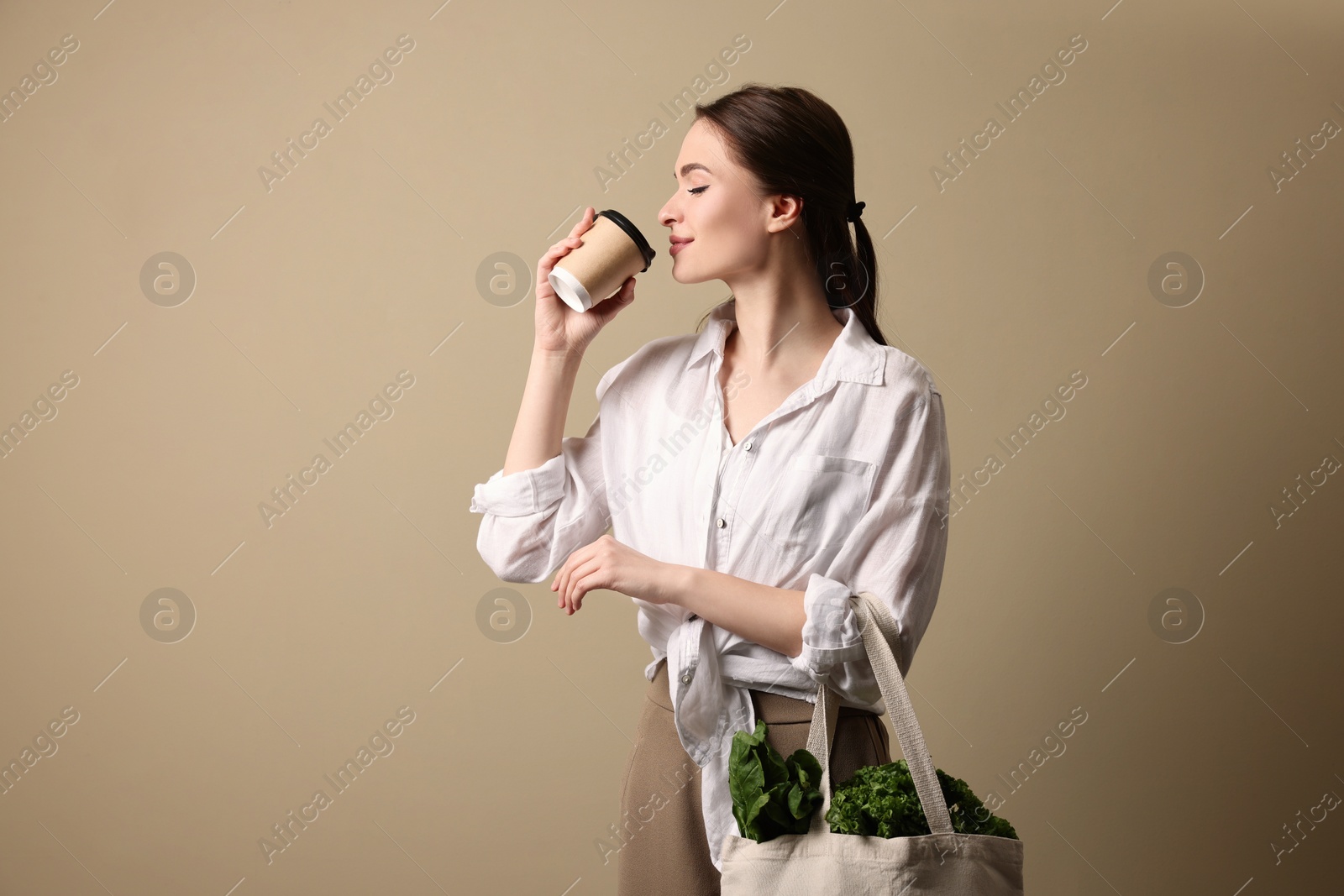 Photo of Woman with eco bag and takeaway cup on beige background