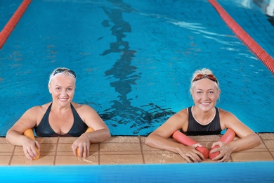 Photo of Sportive senior women in indoor swimming pool