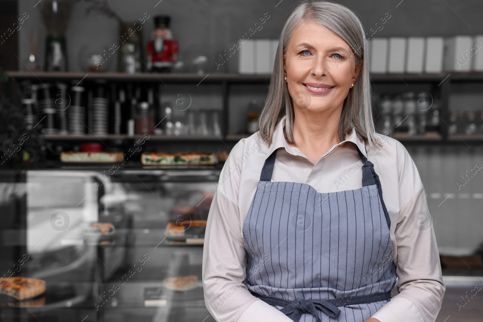 Photo of Portrait of happy business owner in her cafe, space for text