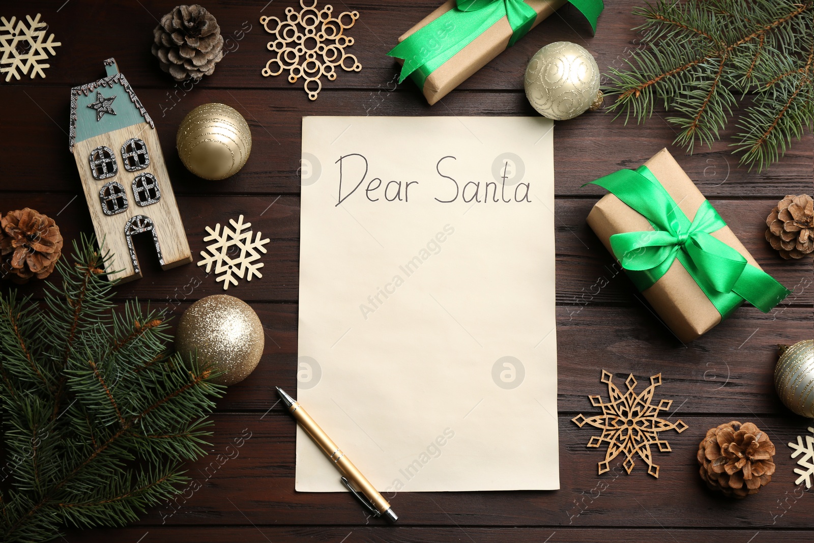 Photo of Flat lay composition with letter saying Dear Santa on wooden table. Space for text