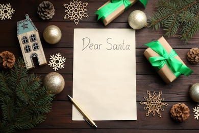 Photo of Flat lay composition with letter saying Dear Santa on wooden table. Space for text