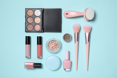 Set of different makeup products on turquoise background, flat lay