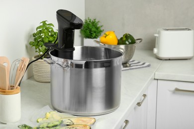 Pot with sous vide cooker in kitchen. Thermal immersion circulator