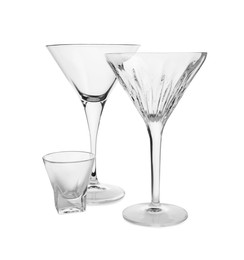 Photo of Elegant empty martini and shot glasses isolated on white