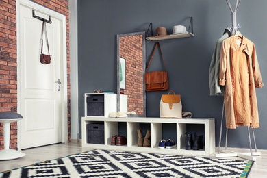 Photo of Stylish hallway interior with mirror and hanger stand