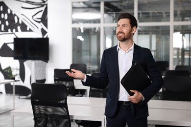 Happy real estate agent with leather portfolio indoors