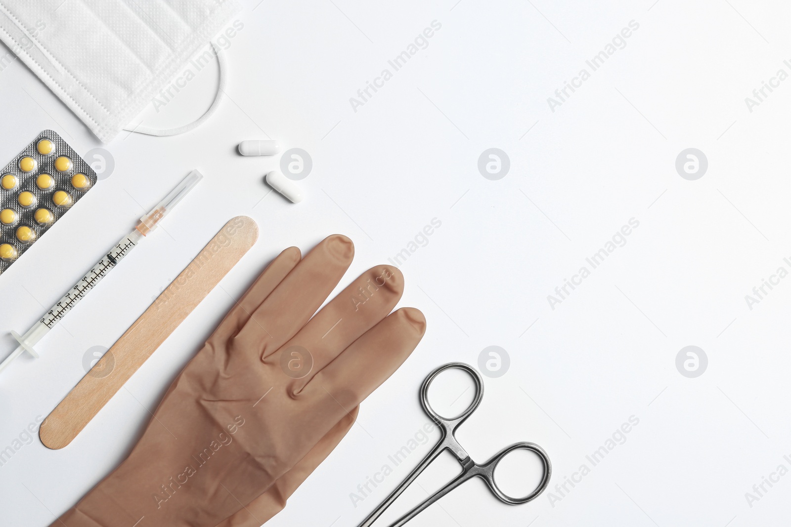 Photo of Flat lay composition with medical glove on white background. Space for text