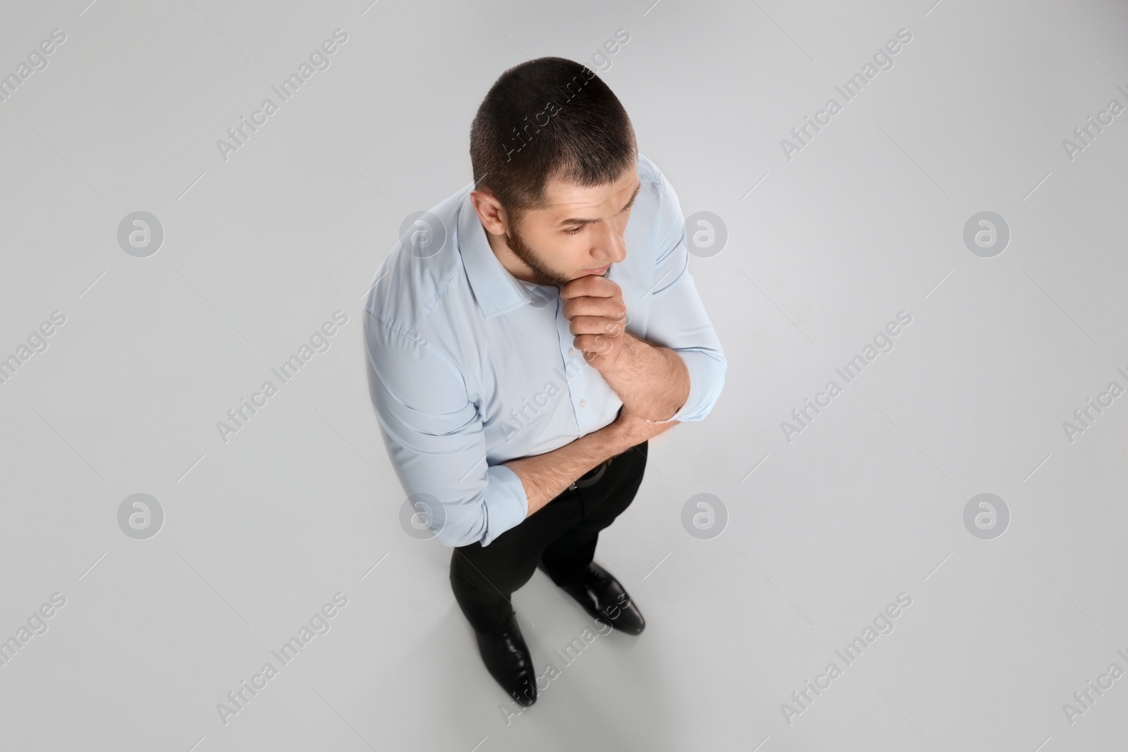 Photo of Man in formal clothes on grey background, above view