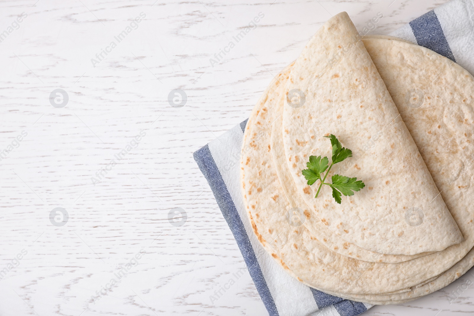 Photo of Flat lay composition with corn tortillas on white wooden background, space for text. Unleavened bread