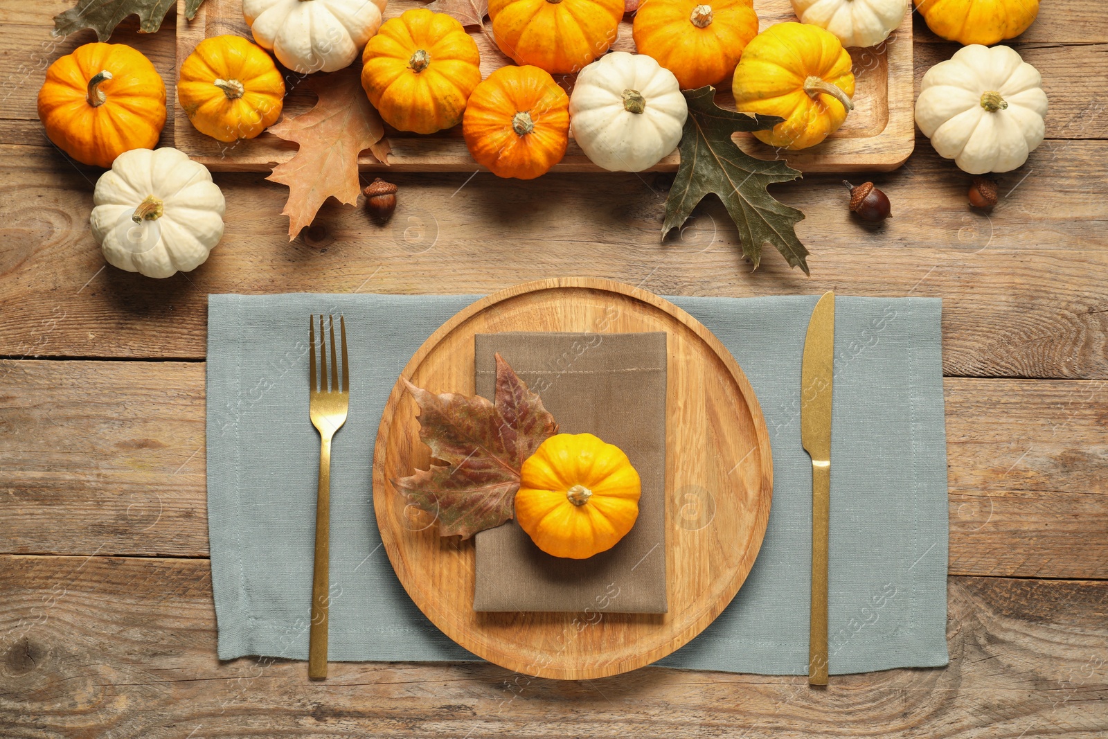 Autumn table setting, pumpkins and dry leaves, flat lay Photo of Autumn table setting, pumpkins and dry leaves, flat lay