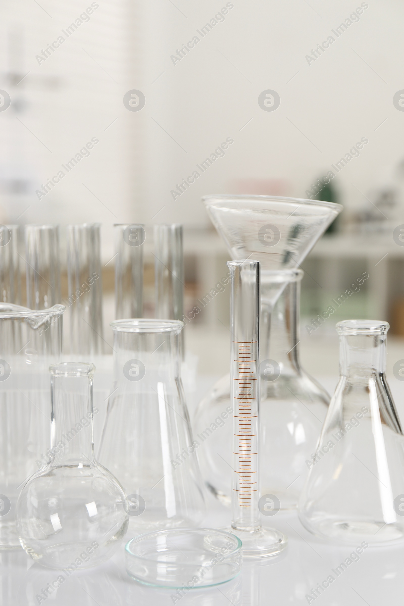 Photo of Laboratory analysis. Different glassware on white table indoors, closeup