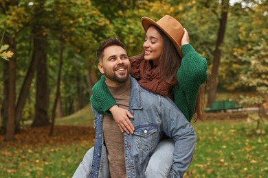 Photo of Happy young couple spending time together in autumn park