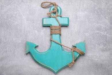 Photo of Wooden anchor with hemp rope on light grey table, top view