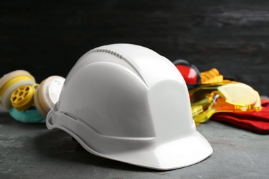 Photo of Hard hat and blurred safety equipment on background