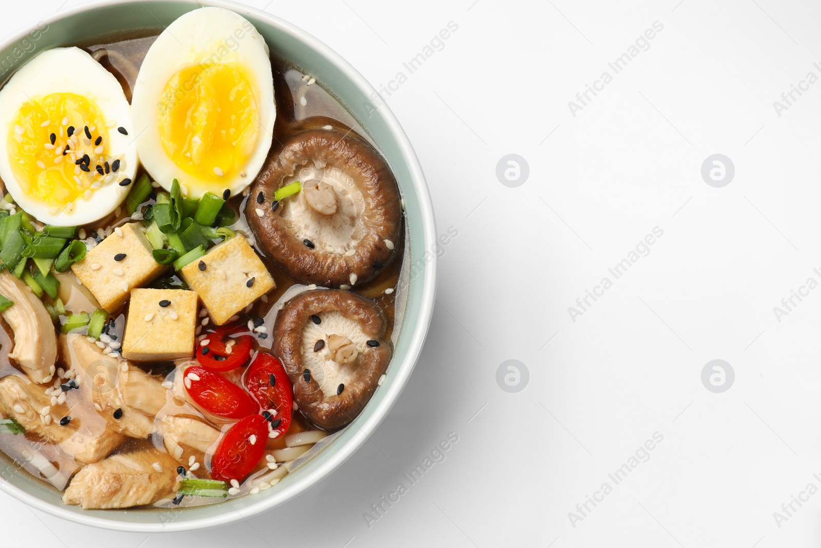 Photo of Bowl of delicious ramen isolated on white, top view. Noodle soup