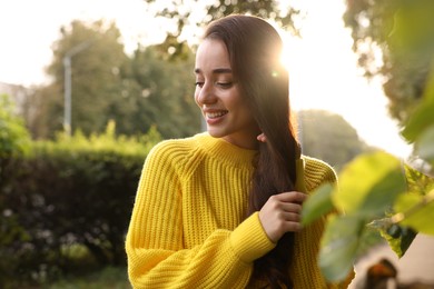 Photo of Beautiful young woman in stylish warm sweater on sunny day