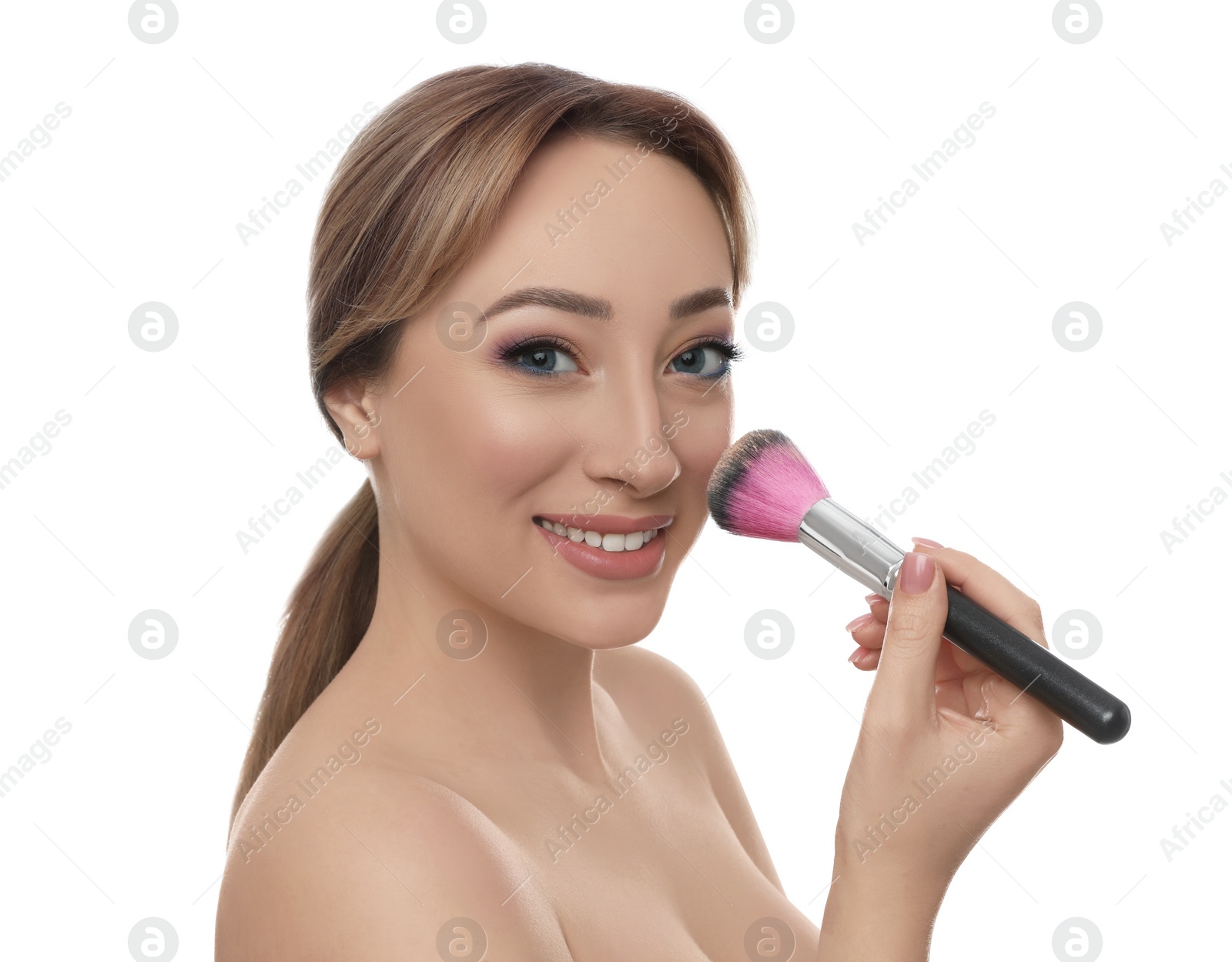 Photo of Beautiful young woman applying face powder with brush on white background