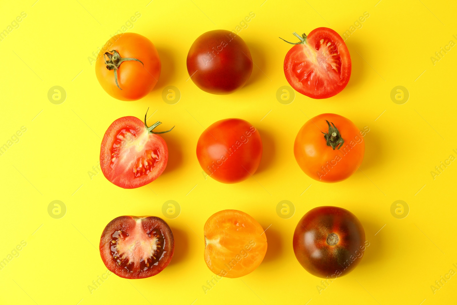 Photo of Flat lay composition with fresh ripe tomatoes on yellow background