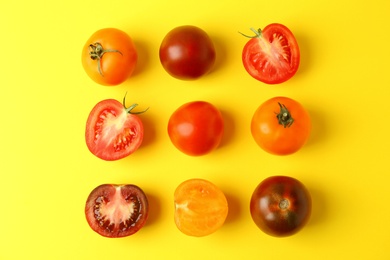 Photo of Flat lay composition with fresh ripe tomatoes on yellow background