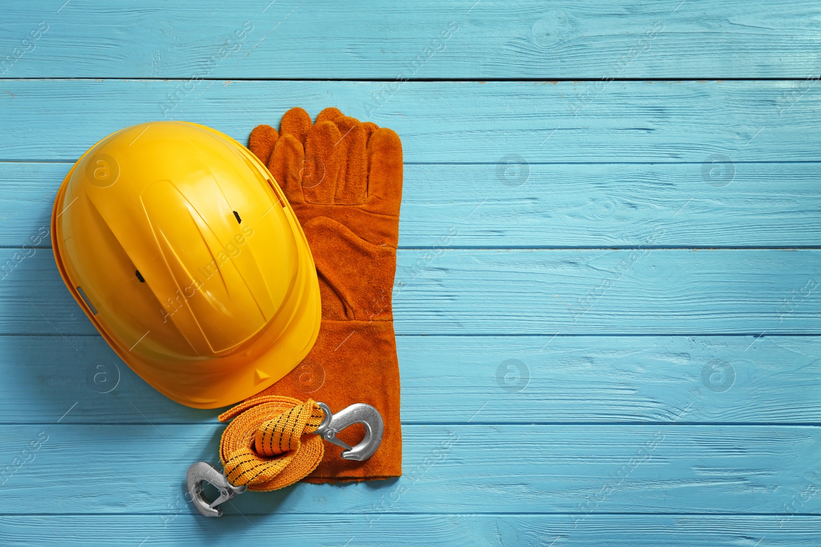 Photo of Flat lay composition with safety equipment and space for text on wooden background