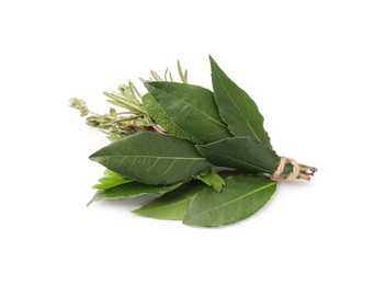 Photo of Bundle of aromatic bay leaves and different herbs isolated on white