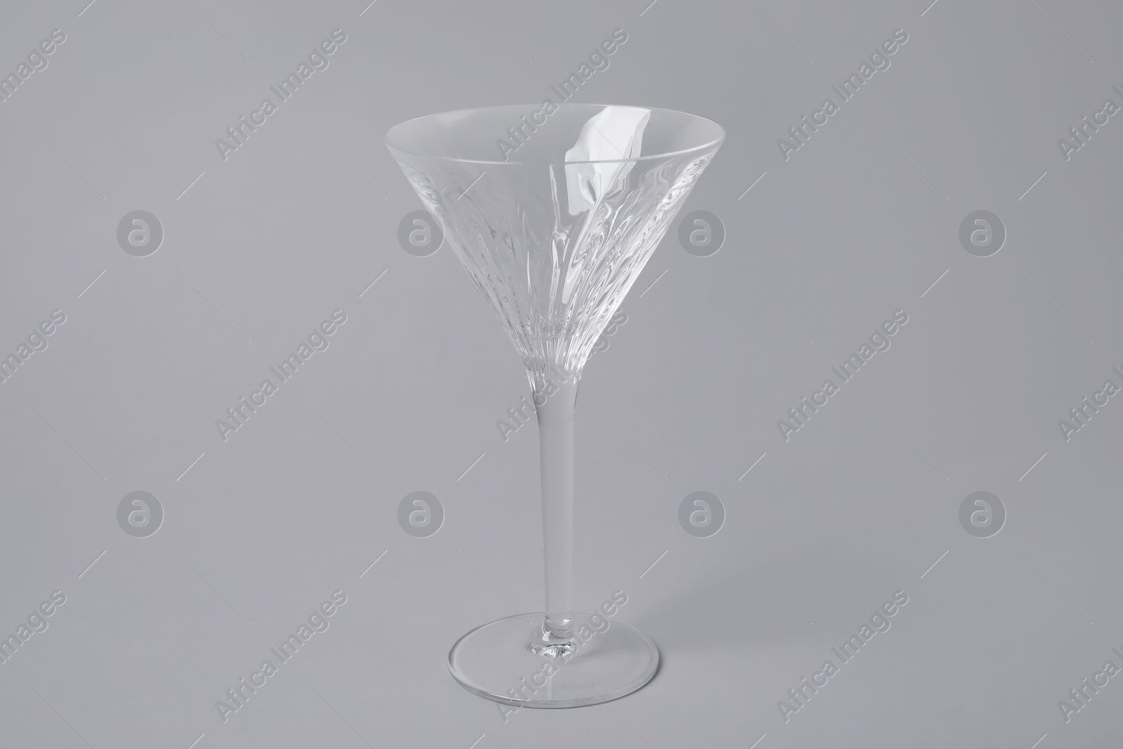 Photo of Empty clean martini glass on grey background