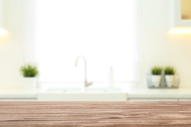 Image of Empty wooden table and blurred view of stylish kitchen interior. Mockup for design