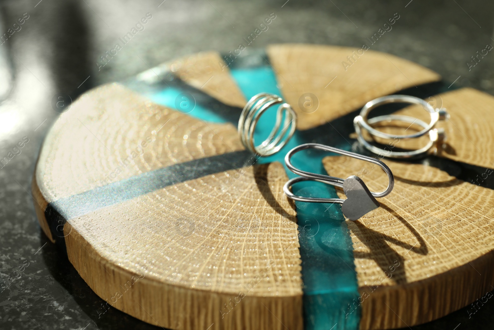 Photo of Stylish presentation of elegant jewelry on grey table, closeup