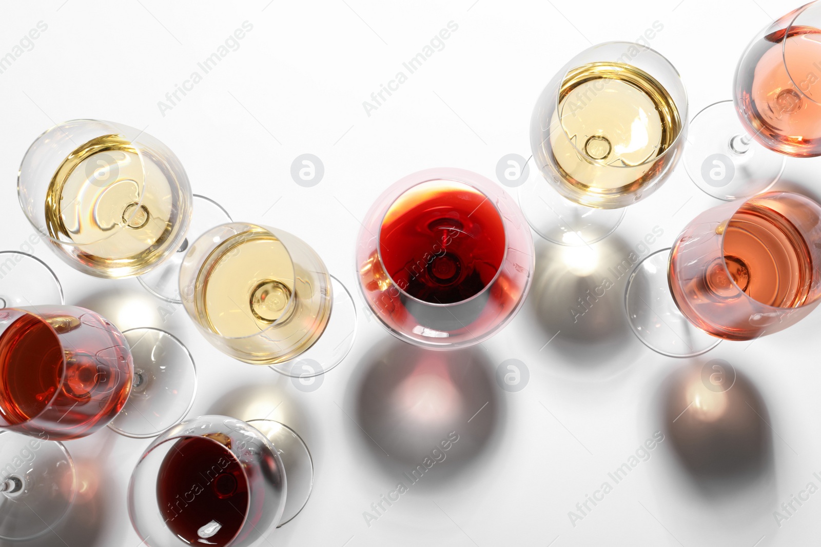 Photo of Different glasses with wine on white background, top view