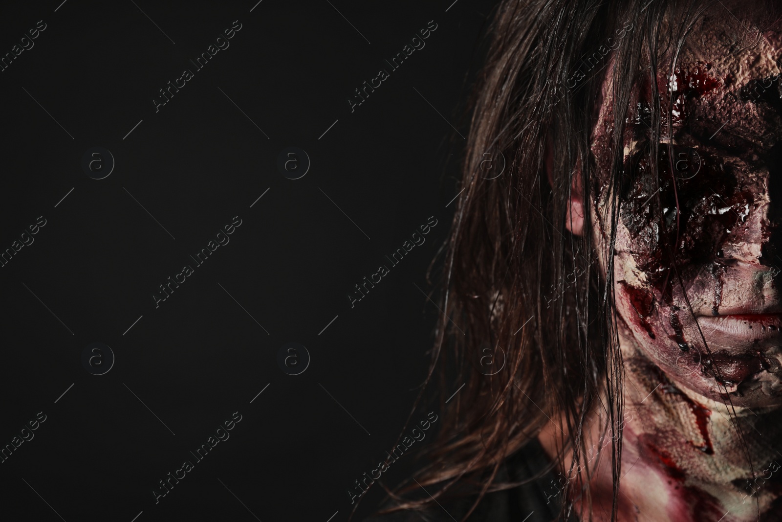 Photo of Scary zombie on dark background, space for text. Halloween monster