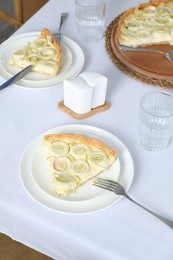 Tasty leek pie and drink served on table