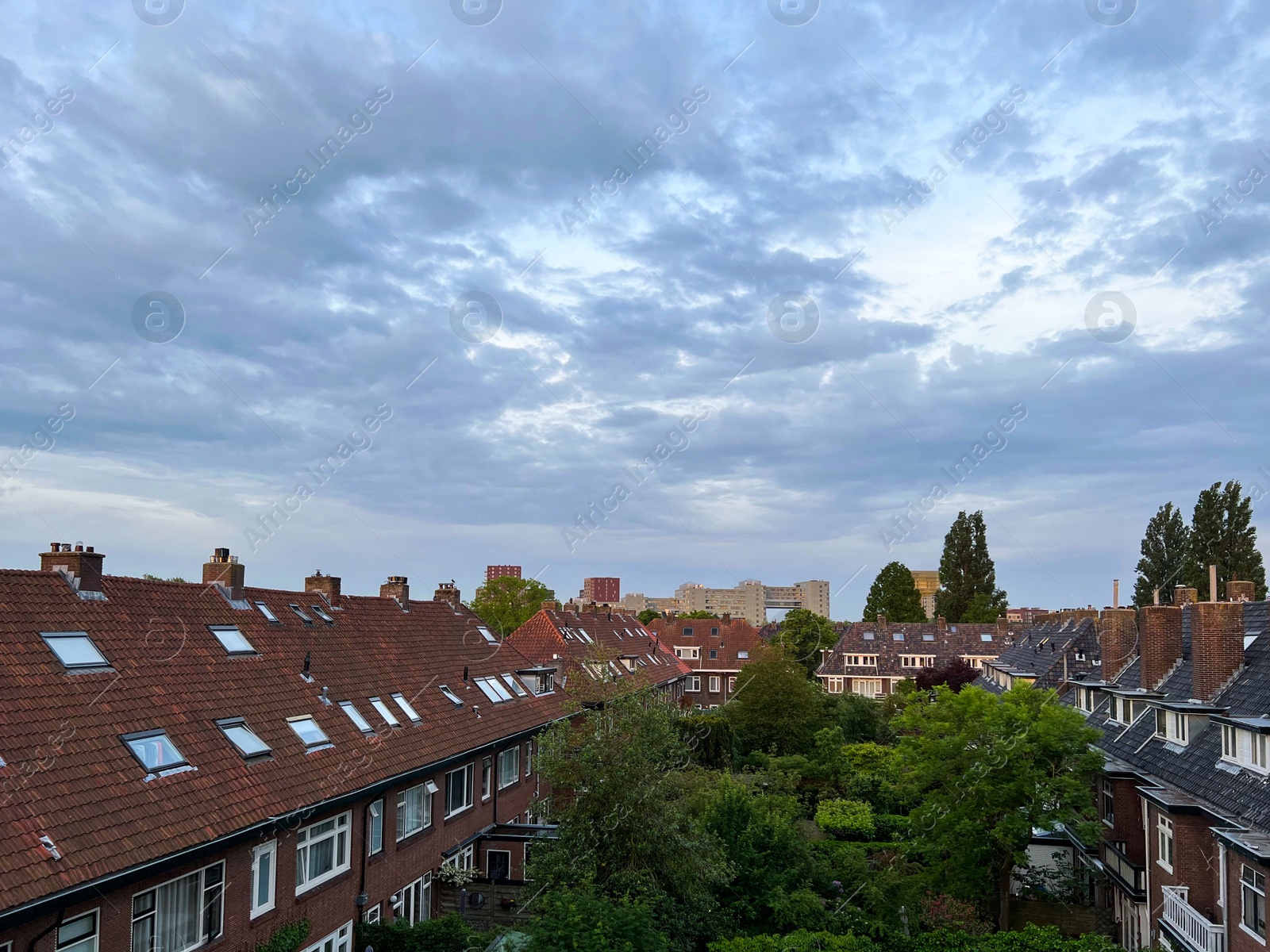 Photo of Picturesque view of city street with beautiful buildings on cloudy day