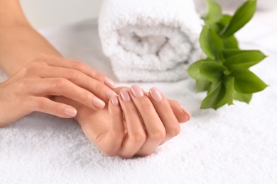 Closeup view of beautiful female hands on towel, space for text. Spa treatment