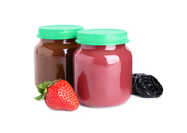 Photo of Jars with baby food, strawberry and dried plum on white background