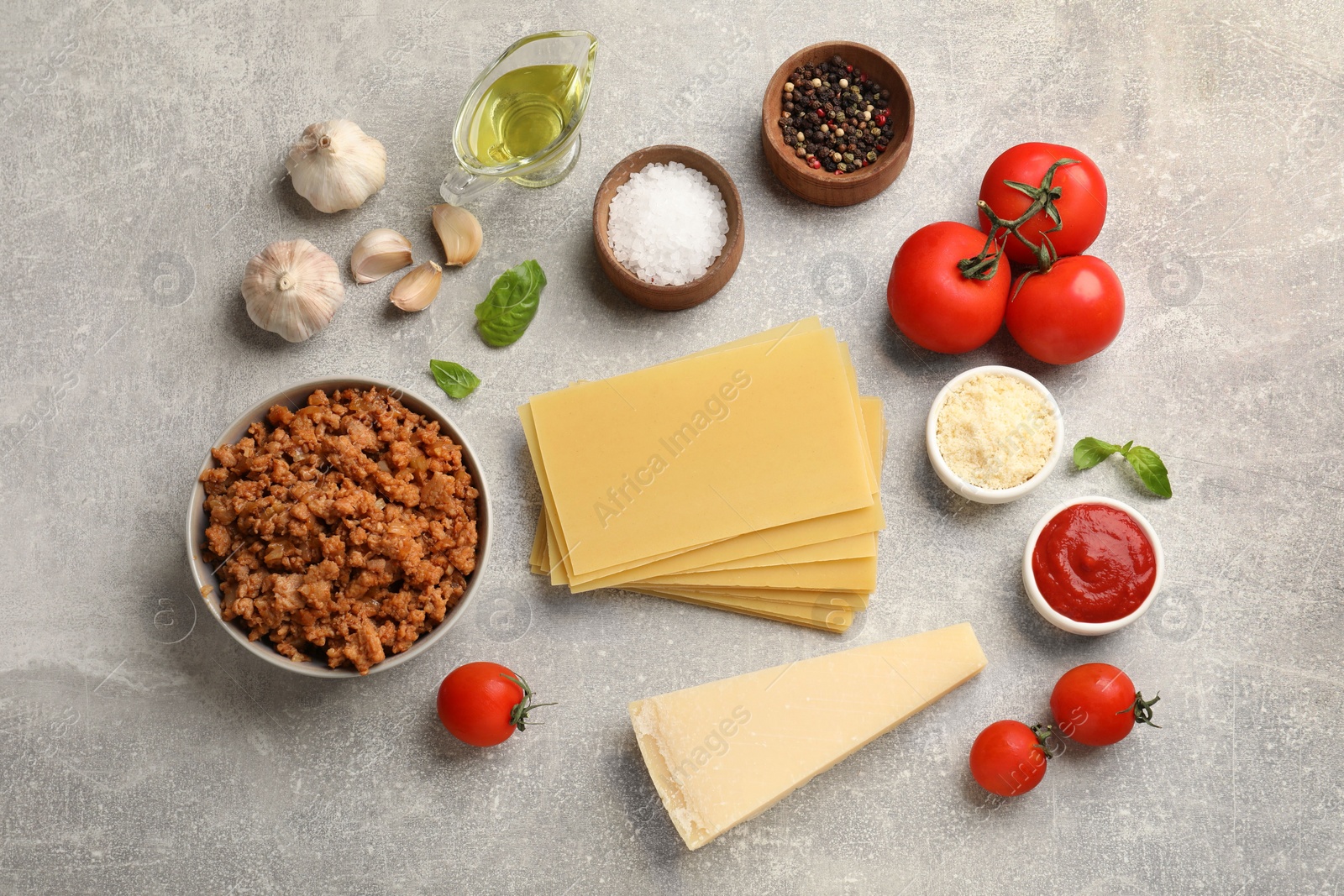 Photo of Flat lay composition with products for cooking lasagna on grey textured table