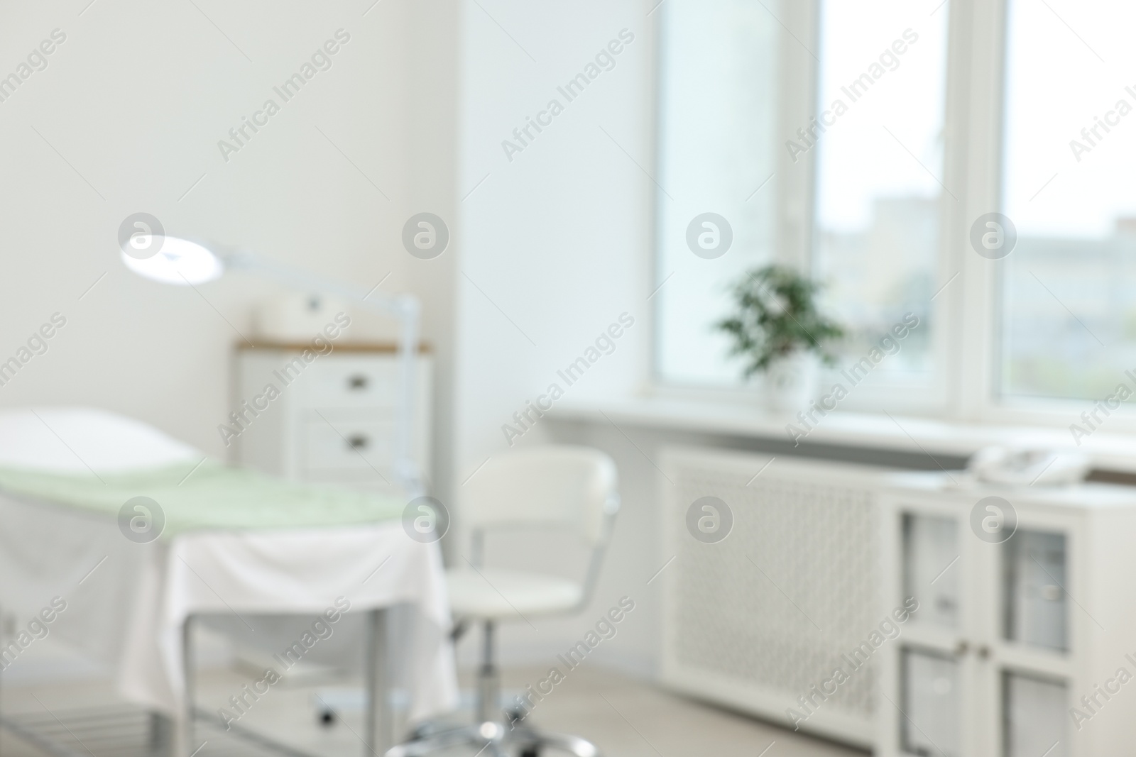 Photo of Modern interior of dermatologist's office with examination table