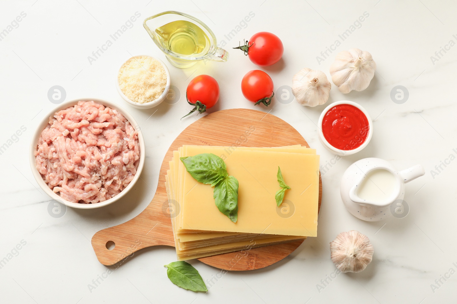 Photo of Ingredients for lasagna on white marble table, flat lay