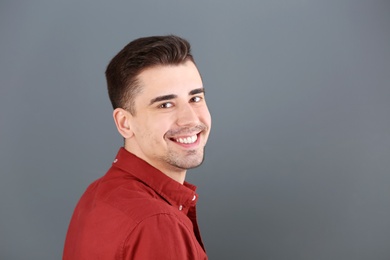 Photo of Charming young man on grey background