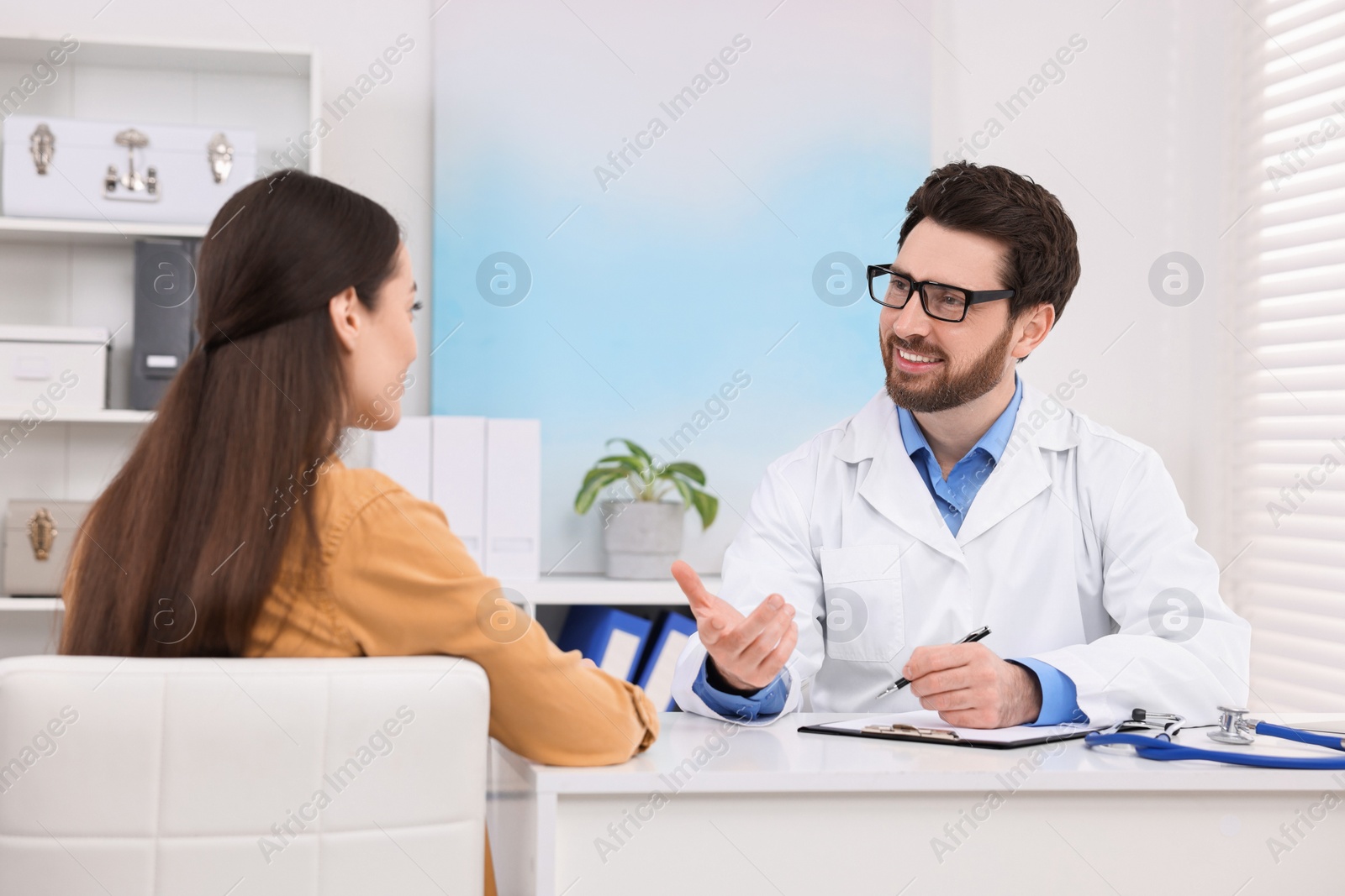 Photo of Doctor consulting patient during appointment in clinic